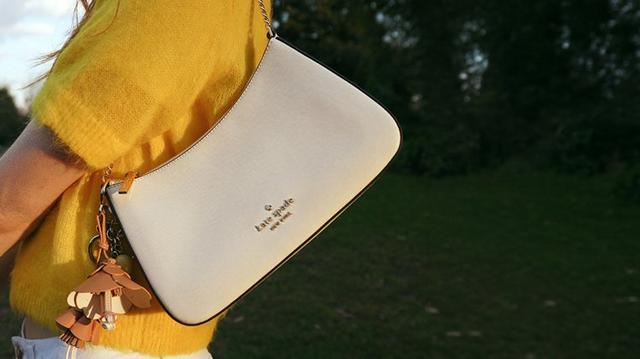 a person in a yellow shirt holding a white object