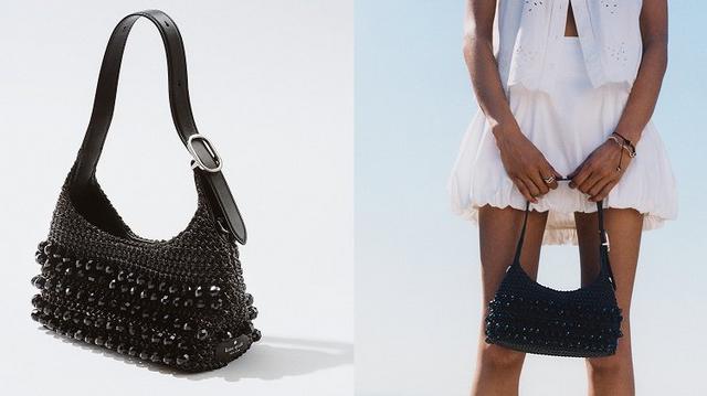 Black beaded shoulder bag with leather strap shown in close-up and worn by model in white outfit.