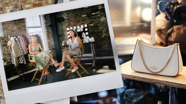 Model wearing brown outfit being filmed in a studio with Kate Spade handbag displayed nearby.