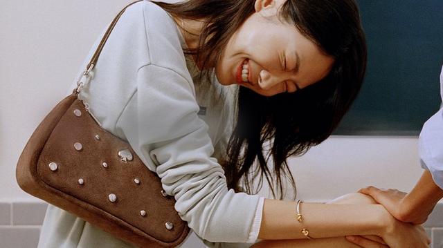 two pictures of a woman with long red hair holding a purse