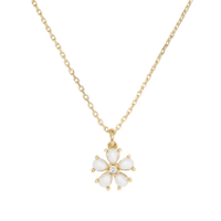 Gold chain necklace with a sun-shaped pendant featuring a pearl center and radiating rays.