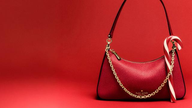 Cream-colored fuzzy bucket bag with brown leather drawstring closure and shoulder strap.