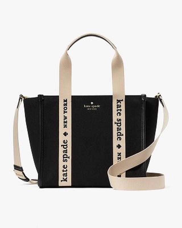 Kate Spade black canvas tote bag with beige handles and shoulder strap featuring brand logo text.