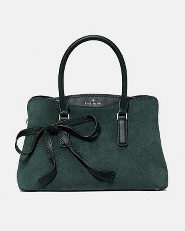 Tan leather tote bag with dual top handles and structured silhouette.