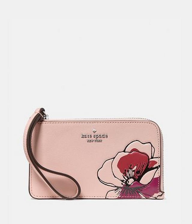 Kate Spade New York blush pink wristlet with large floral design at corner.