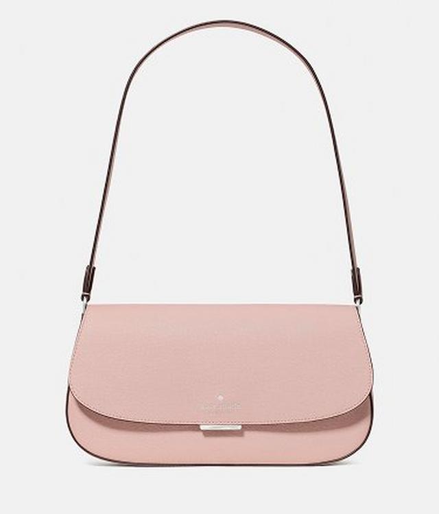 Pink leather shoulder bag with brown adjustable strap and curved flap closure.