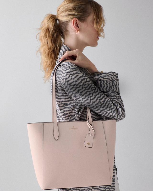 DOTD LEFT - woman standing with a pink kate spade bag