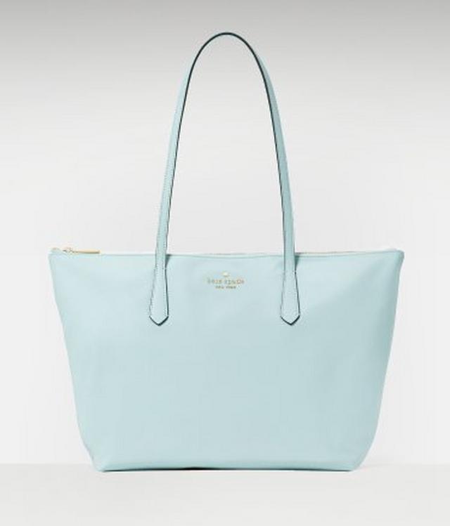Kate Spade light blue leather tote bag with top zip closure and dual shoulder straps.