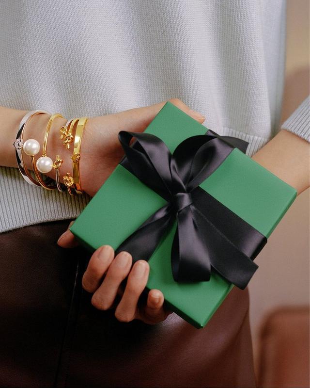 Person holding a gift box behind their back