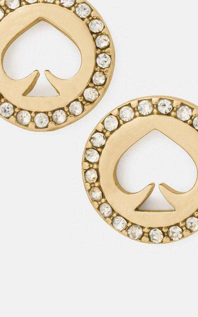 Gold-tone circular stud earrings with spade cutouts and crystal embellishments around the edges.