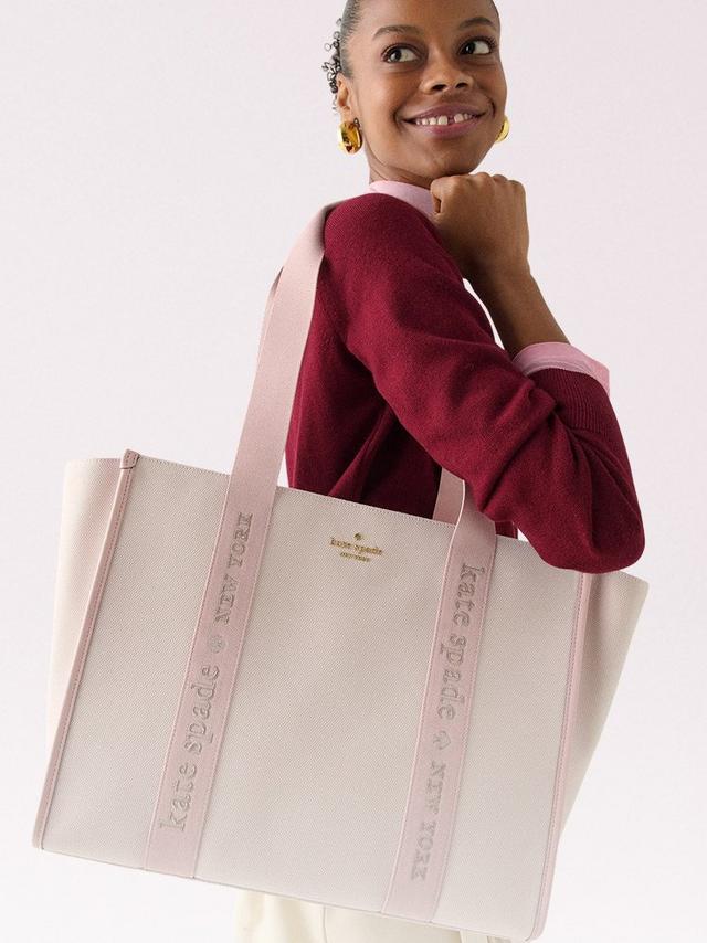 Two man carrying kate spade tote bag