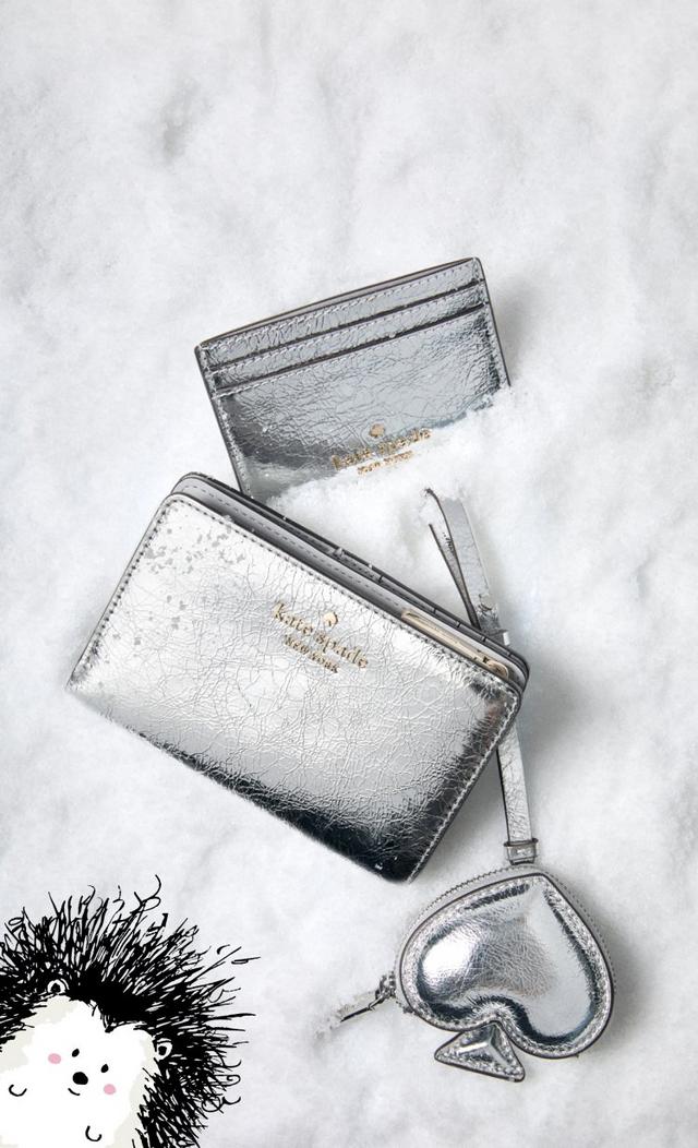 three bags of different colors are sitting in the snow