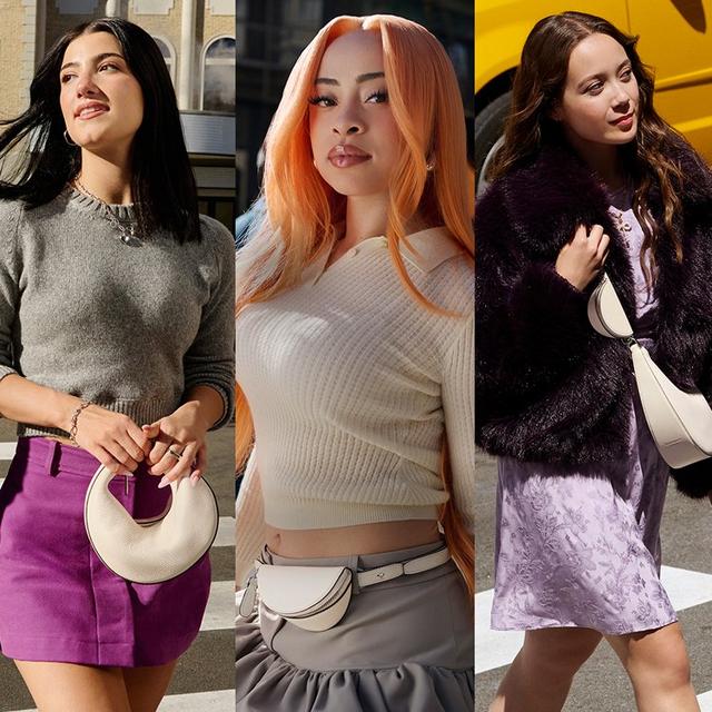 three women in different outfits walking down the street