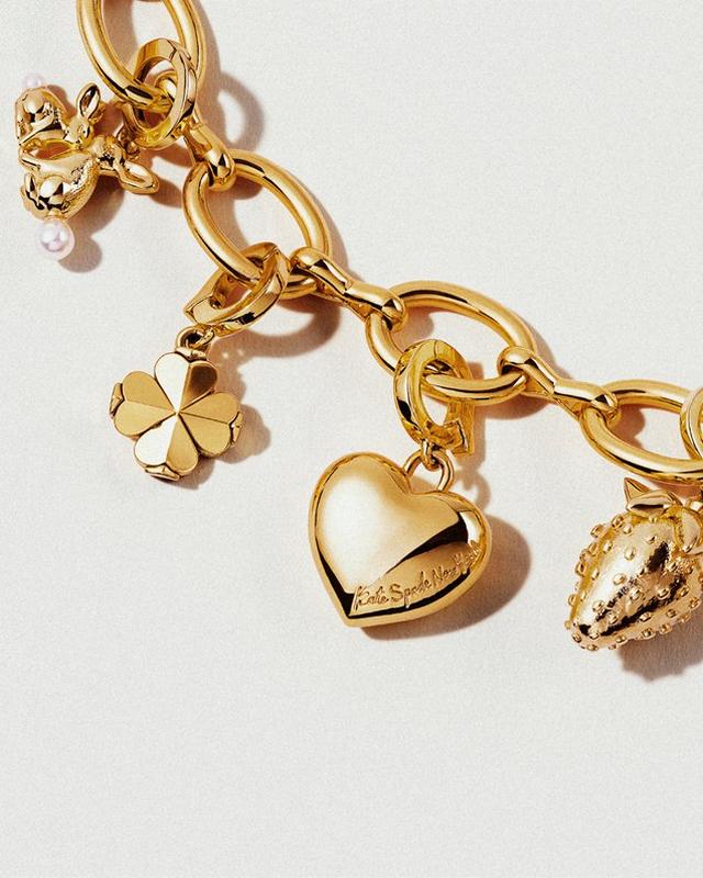a gold bracelet with charms and a heart charm