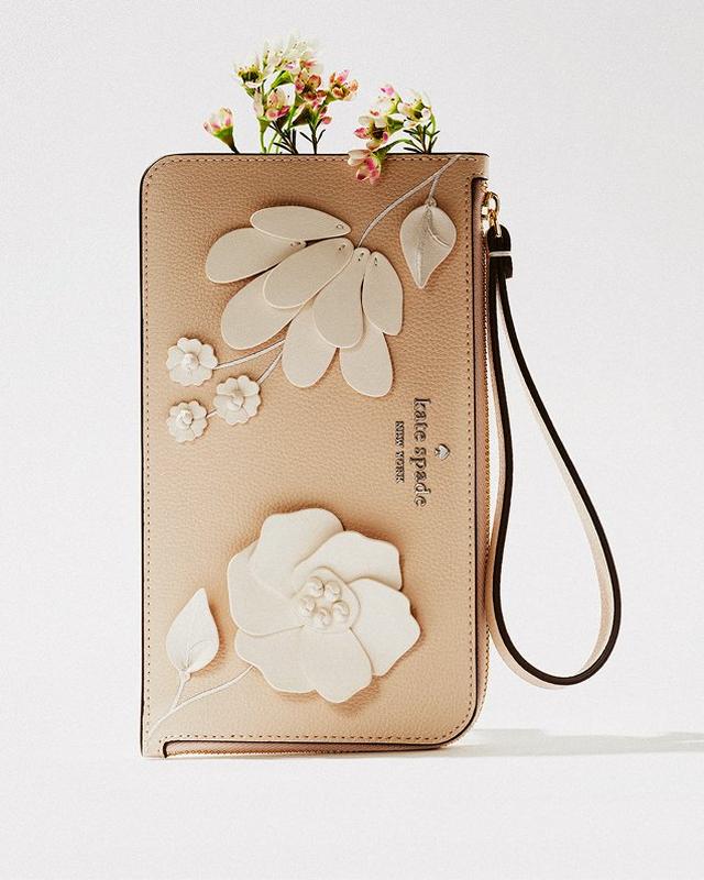 a wristlet with flowers on it sitting on a white surface