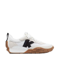 White athletic shoe with black N logo and brown suede heel detail on gum rubber sole.