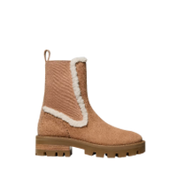 Tan quilted ankle boot with white sherpa lining and chunky lug sole.